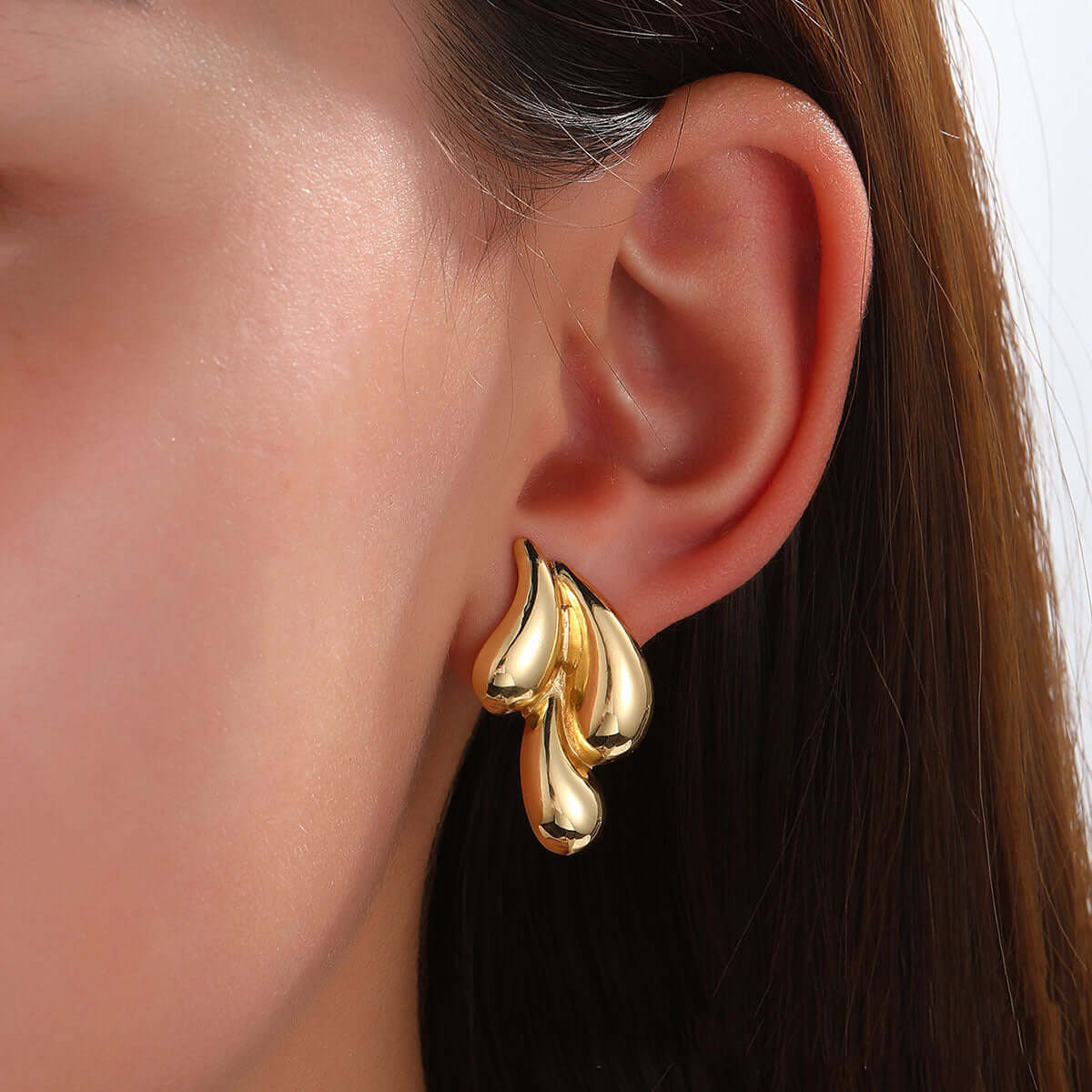Cry Me a River gold sculptural statement earrings on model – Links & Loops Jewellery
