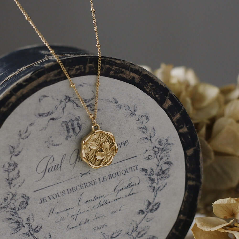 Gold medallion pendant necklace with embossed floral design – Links & Loops Jewellery