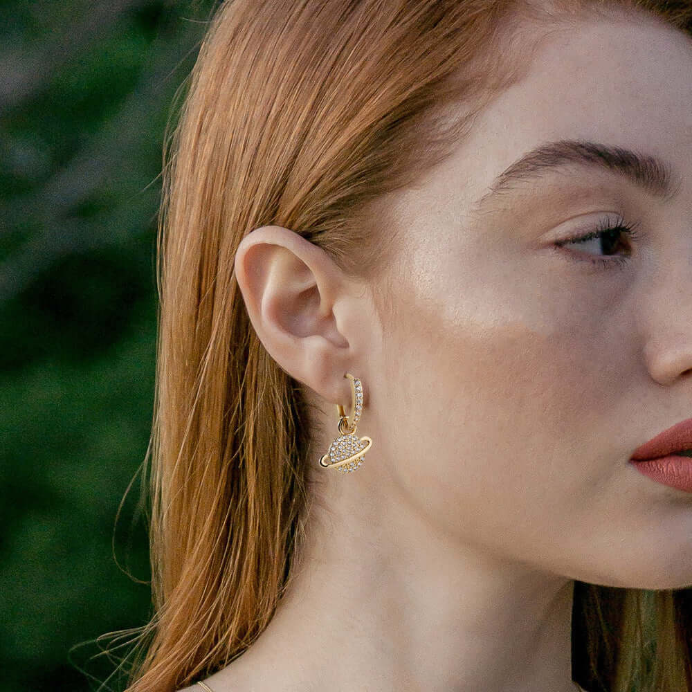 Gold planet-shaped hoop earrings on model – Links & Loops Jewellery